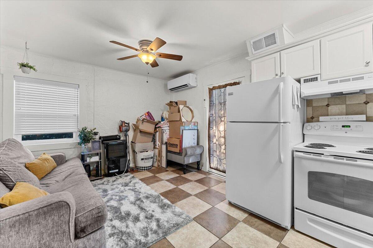 931 Rio Street Red Bluff, CA 96080 - Photo 38 of 54 a kitchen with stainless steel appliances granite countertop a refrigerator a stove a sink dishwasher and a dining table with wooden floor