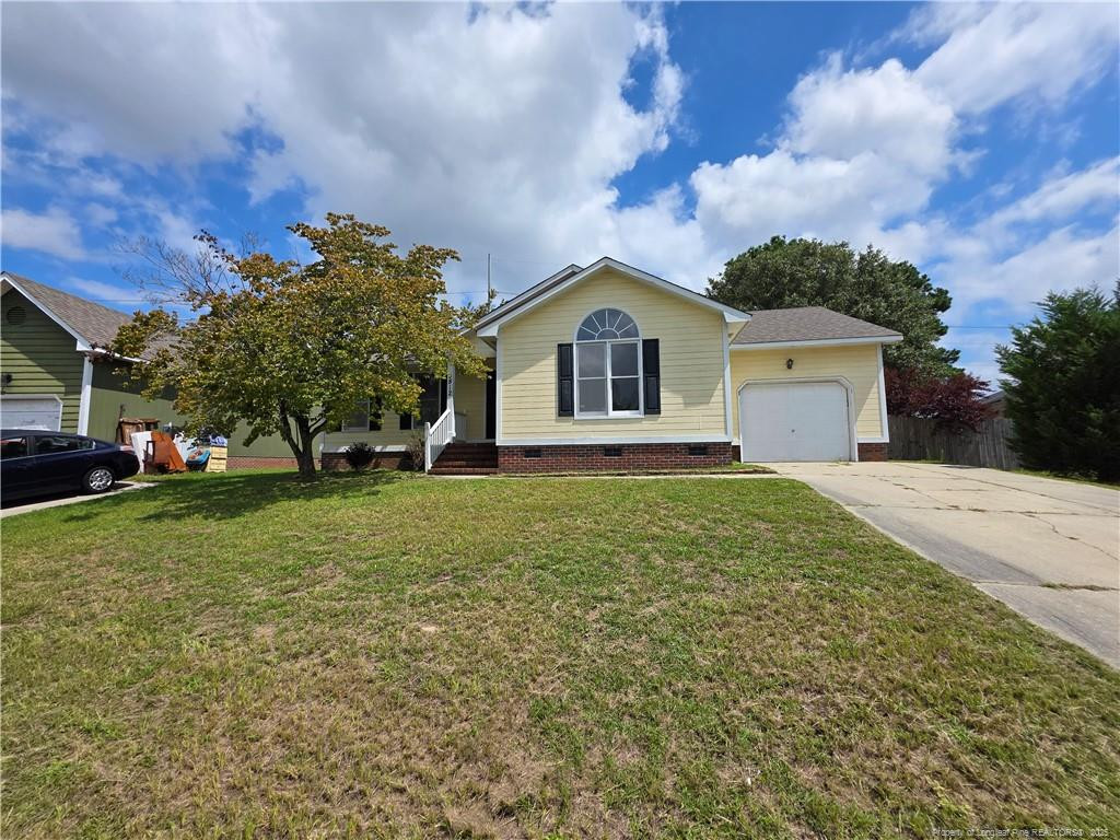 a front view of a house with a garden and trees