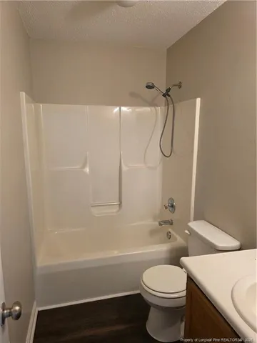 a bathroom with a toilet and a bath tub
