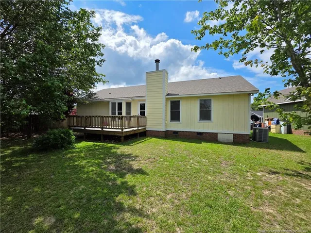 a view of a house with a backyard