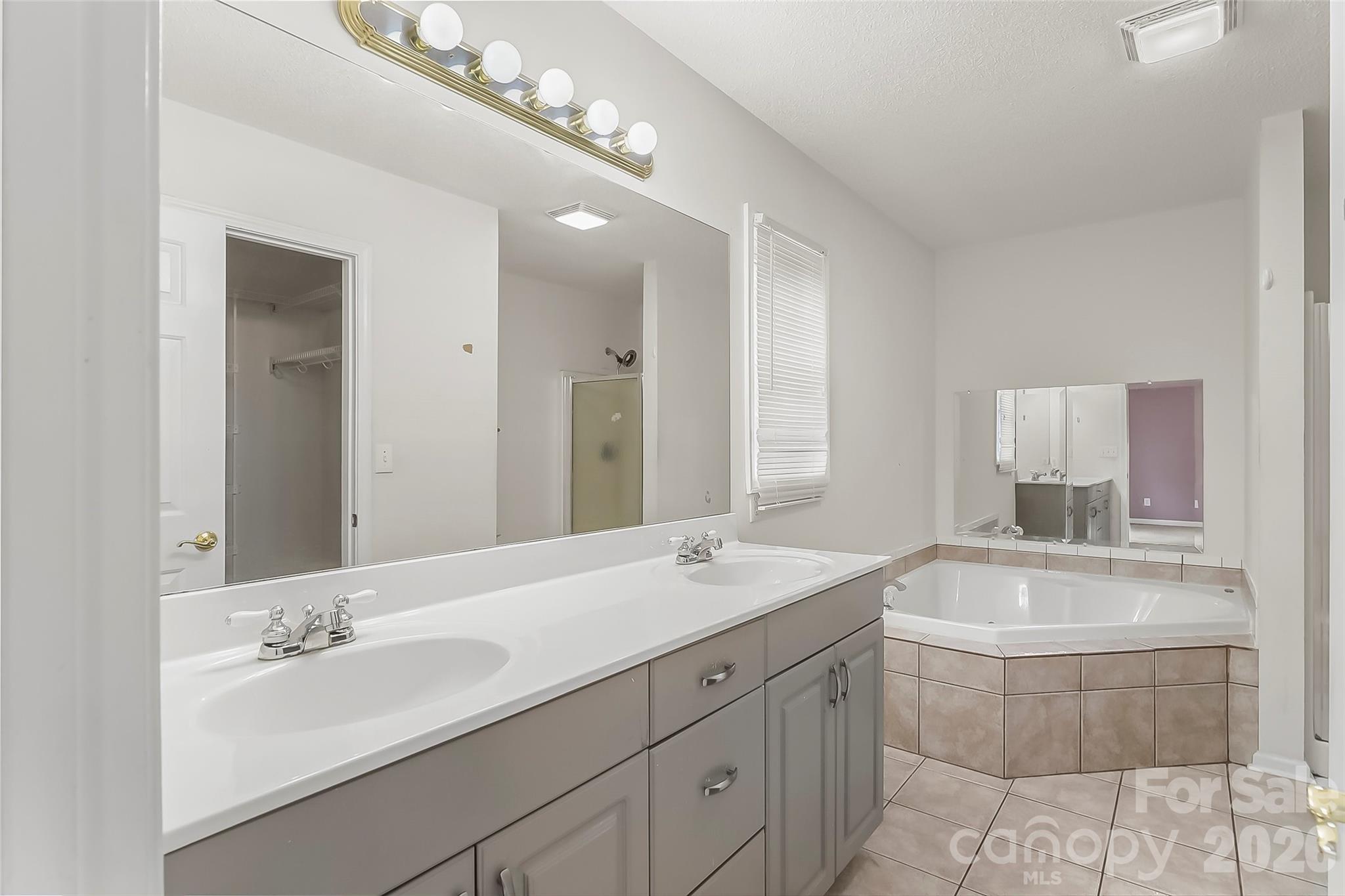 1926 Timber Trace Morganton, NC 28655 - Photo 14 of 36 a bathroom with a sink double vanity granite tub and a mirror