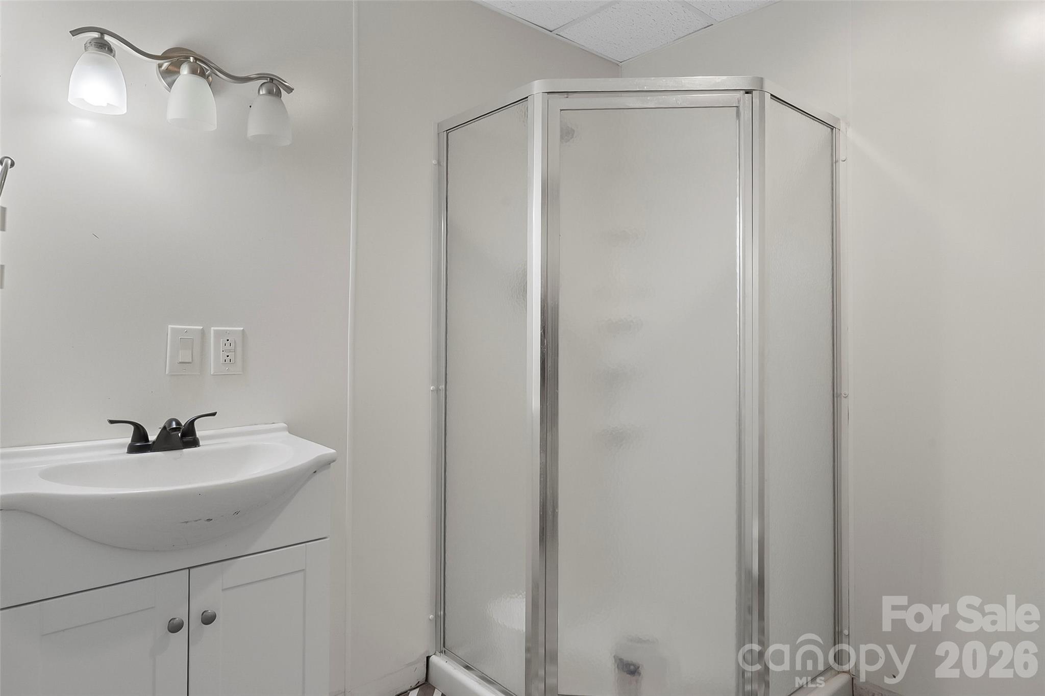 1926 Timber Trace Morganton, NC 28655 - Photo 25 of 36 a bathroom with a sink a mirror and shower