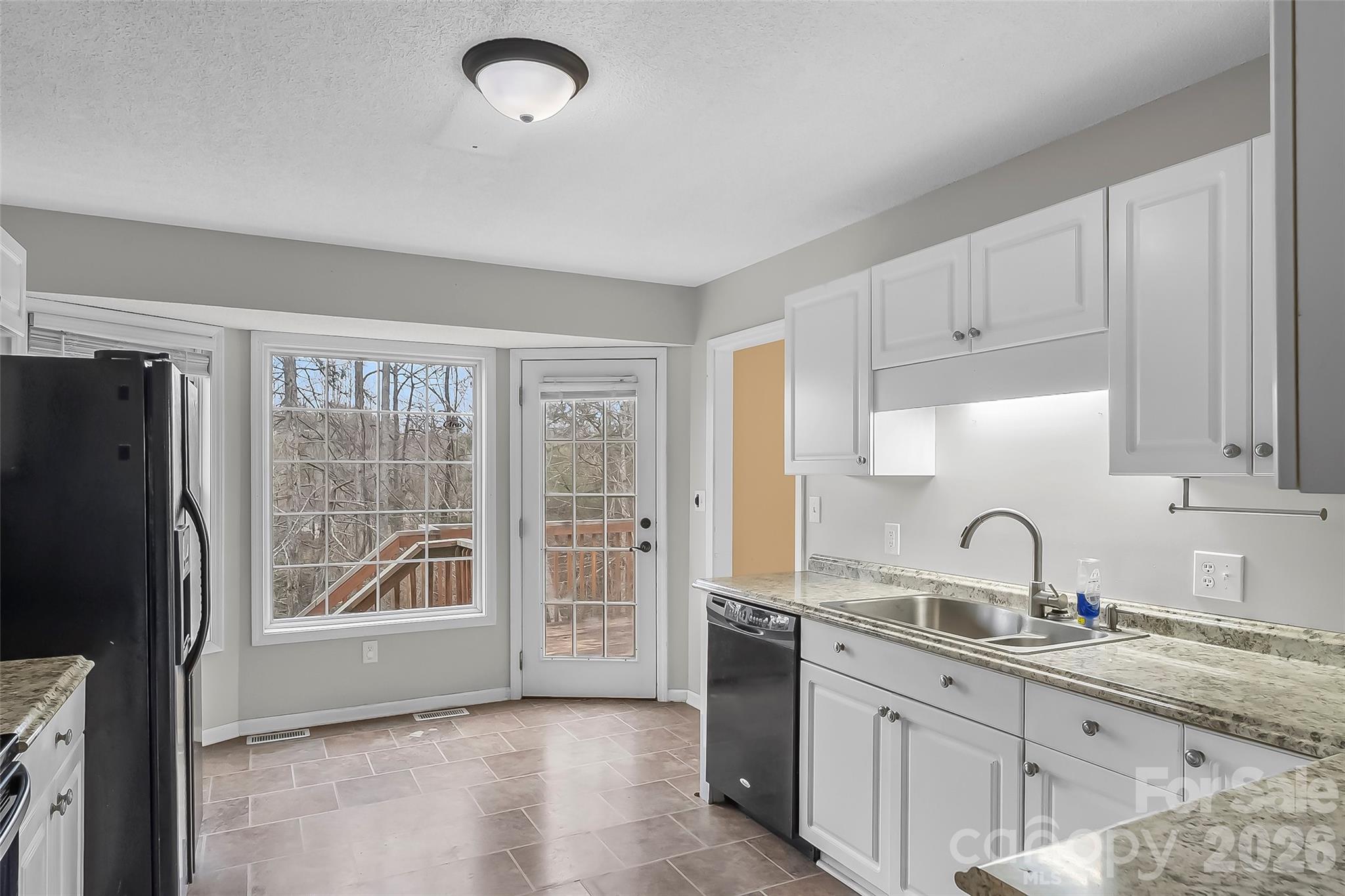 1926 Timber Trace Morganton, NC 28655 - Photo 10 of 36 a kitchen with granite countertop a sink and a refrigerator