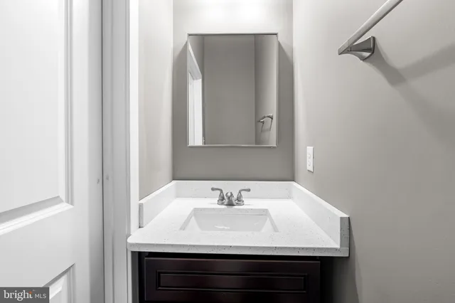 a close view of a sink and a mirror in a bathroom