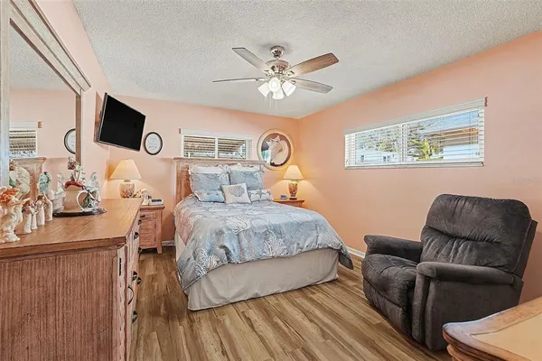 a bedroom with a bed couch and a window