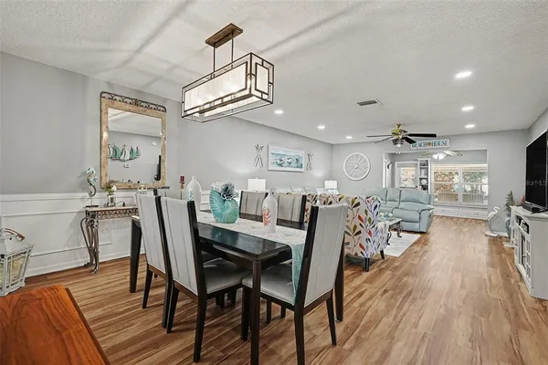a view of a dining room with furniture and wooden floor
