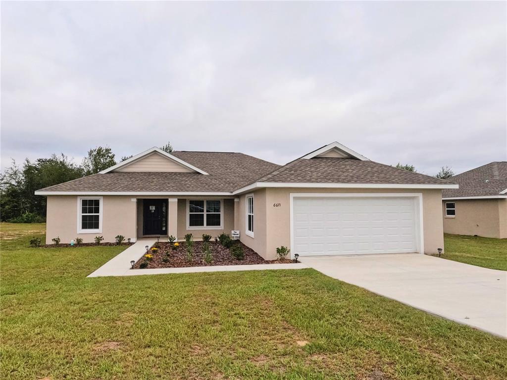 6725 Southwest 64th Avenue Ocala, FL 34476 - Photo 1 of 1 a front view of house with yard and trees in the background