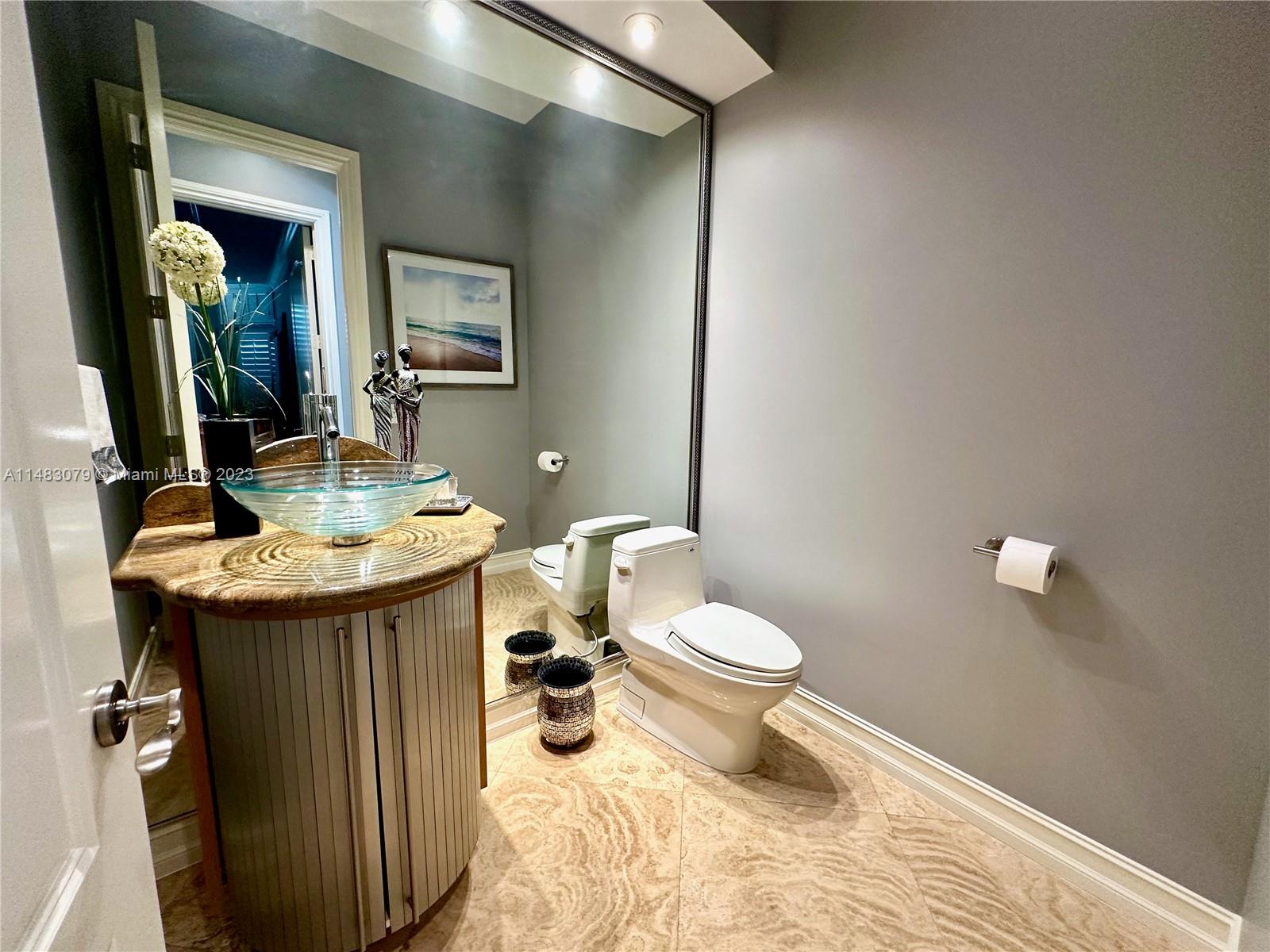 465 Northeast 2nd Street Boca Raton, FL 33432 - Photo 15 of 73 a bathroom with a sink toilet and mirror