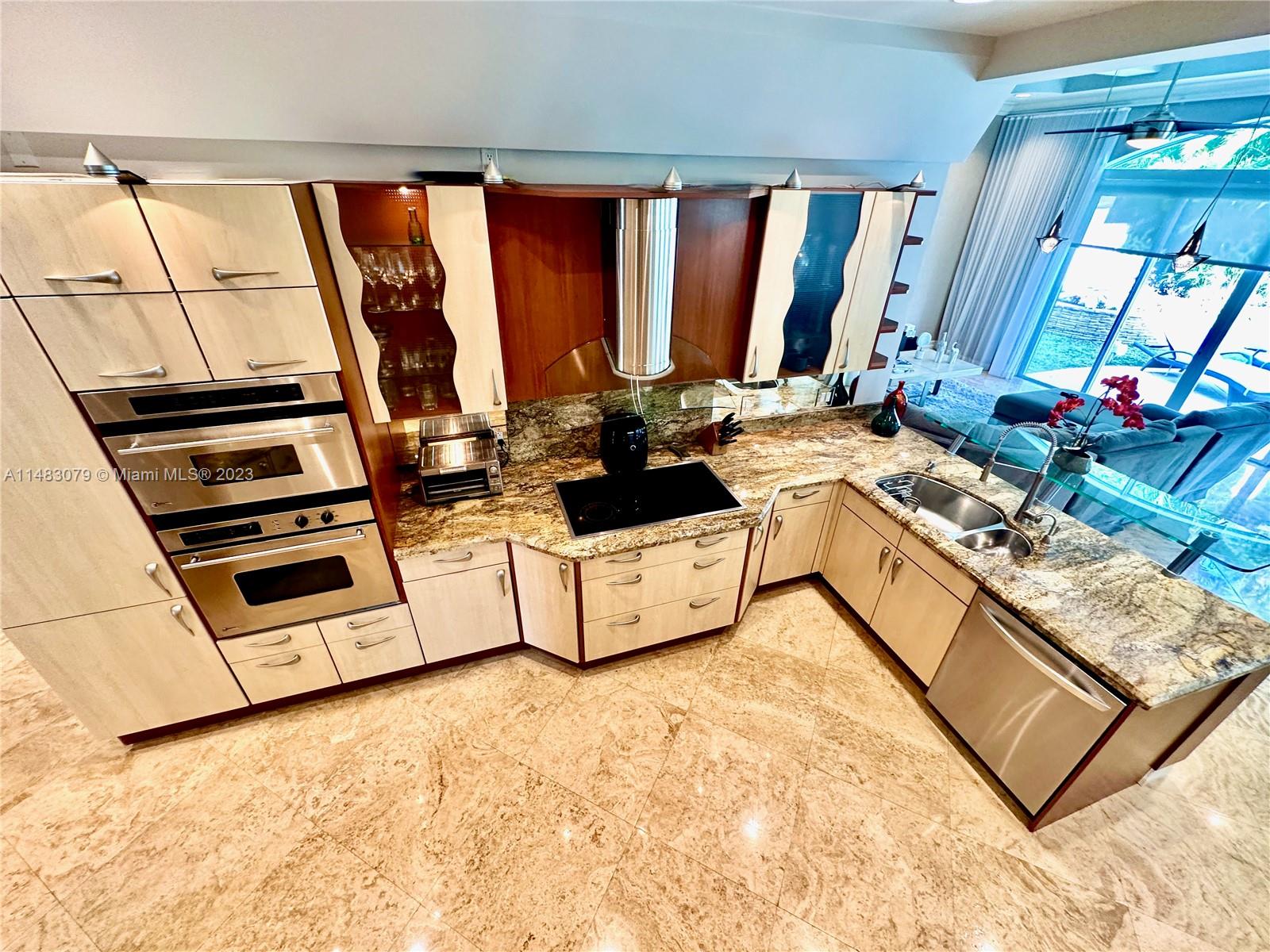 465 Northeast 2nd Street Boca Raton, FL 33432 - Photo 19 of 73 a view of a kitchen with stainless steel appliances granite countertop a stove and a sink