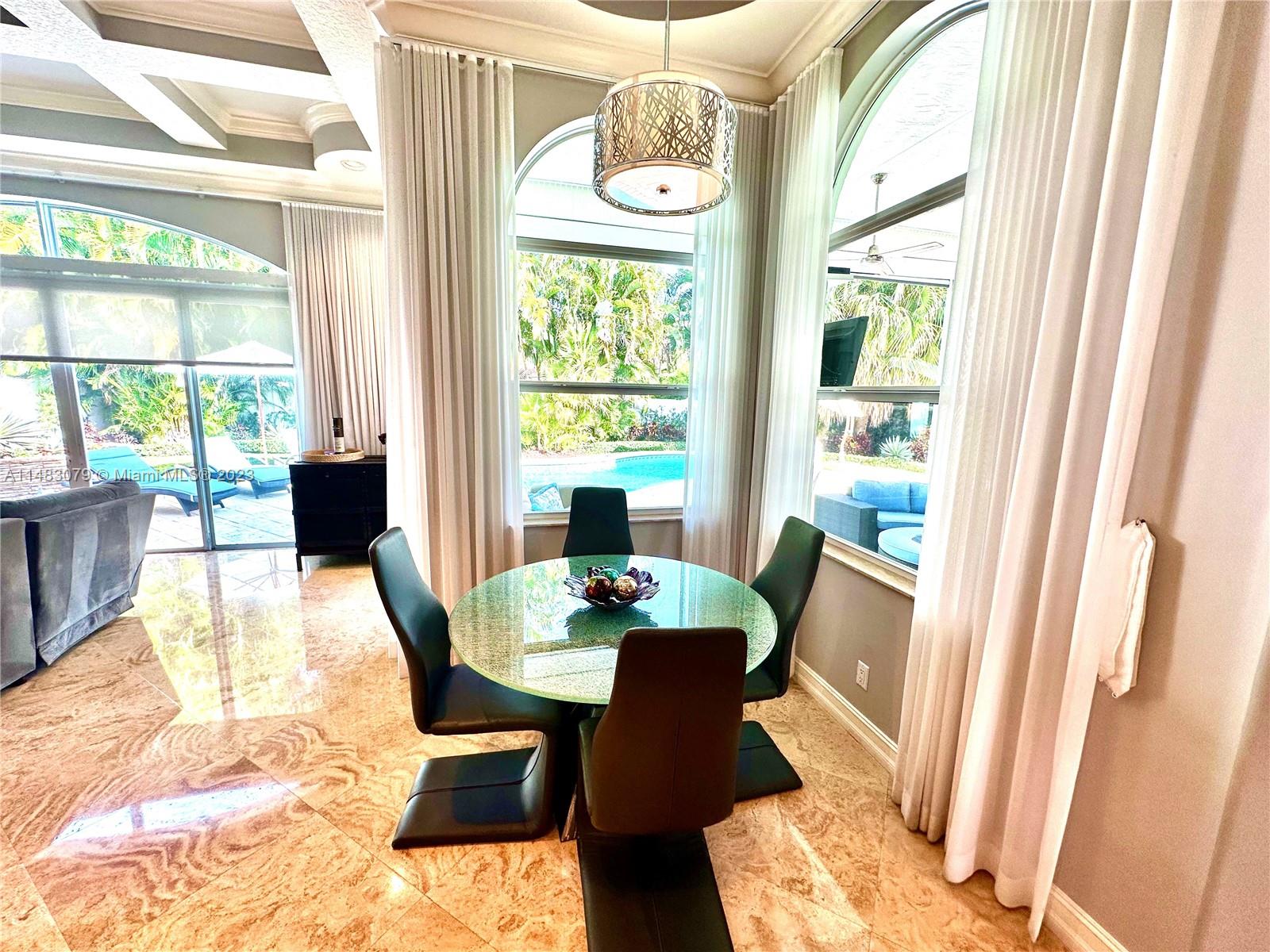 465 Northeast 2nd Street Boca Raton, FL 33432 - Photo 23 of 73 a dining room with furniture a chandelier and wooden floor