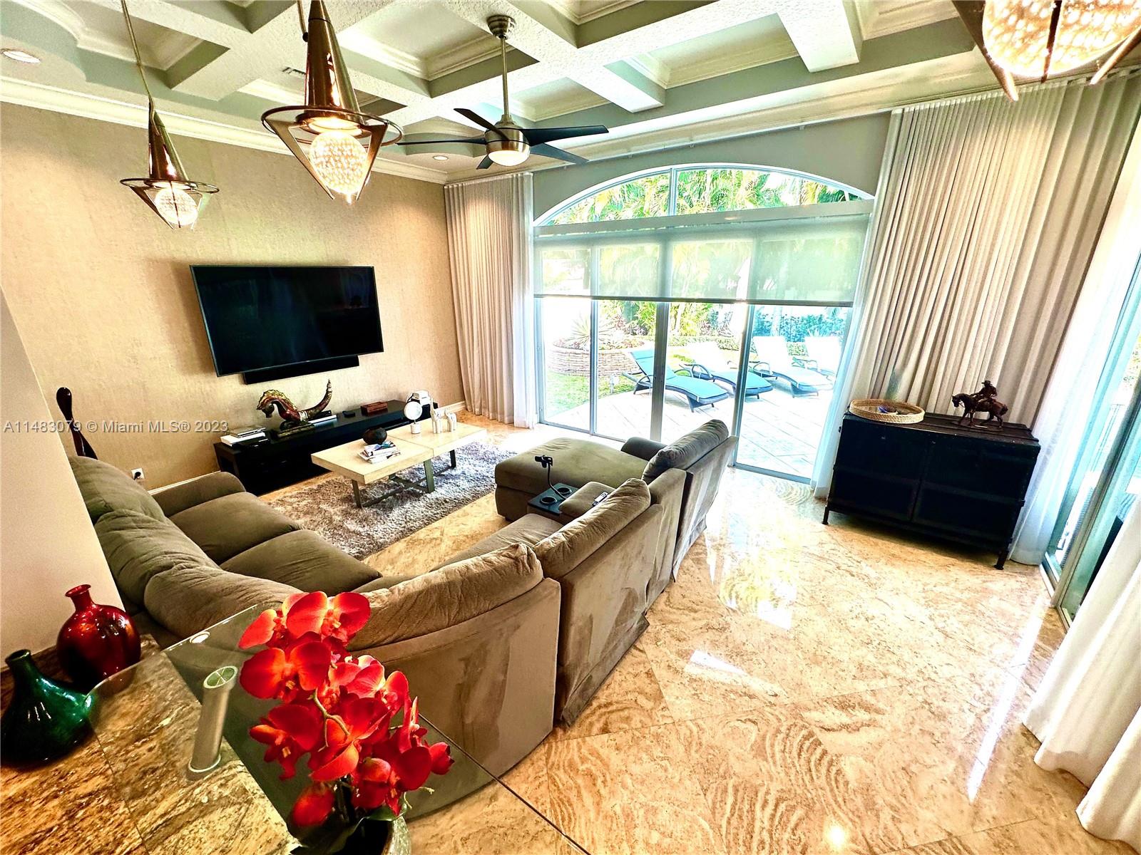 465 Northeast 2nd Street Boca Raton, FL 33432 - Photo 25 of 73 a living room with furniture and a flat screen tv