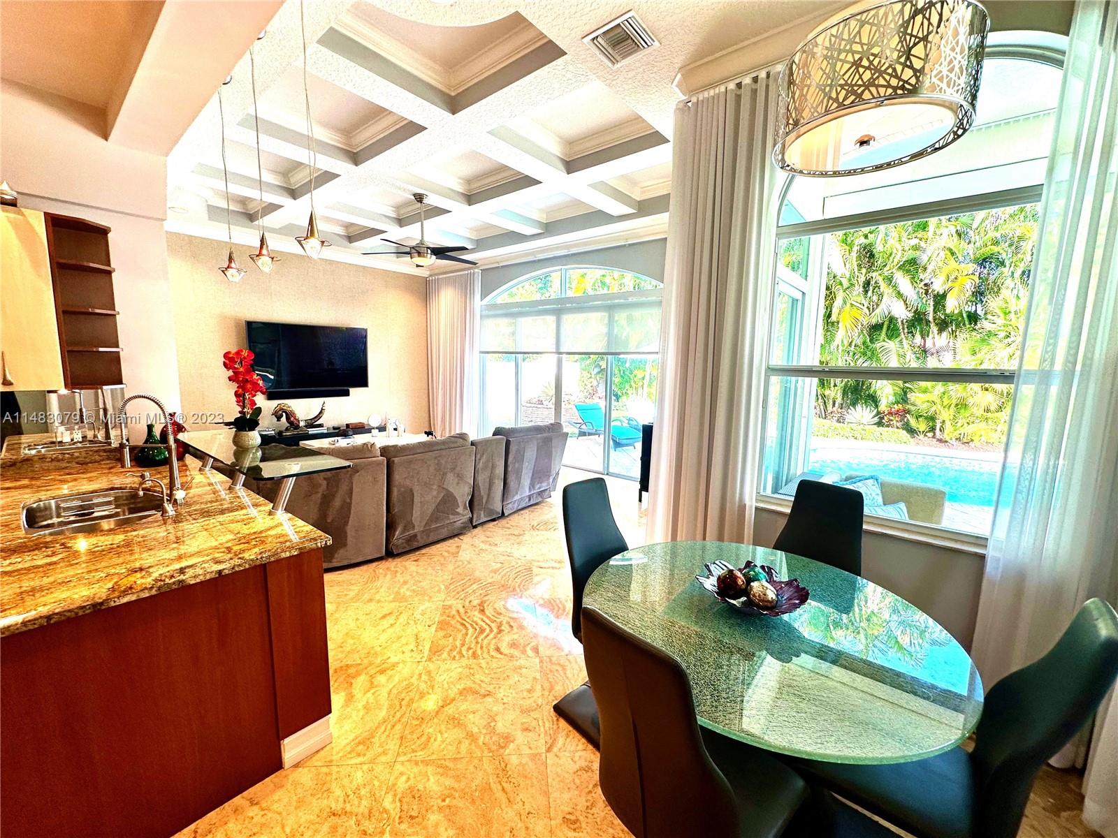 465 Northeast 2nd Street Boca Raton, FL 33432 - Photo 26 of 73 a view of a dining room with furniture a chandelier and wooden floor