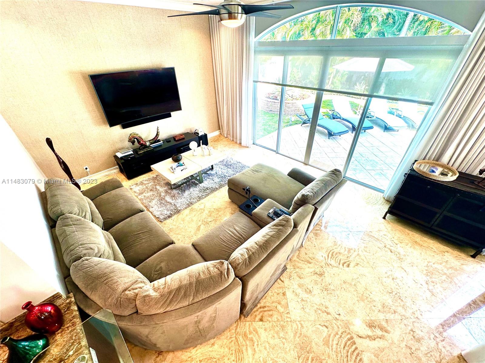 465 Northeast 2nd Street Boca Raton, FL 33432 - Photo 27 of 73 a living room with furniture and a flat screen tv