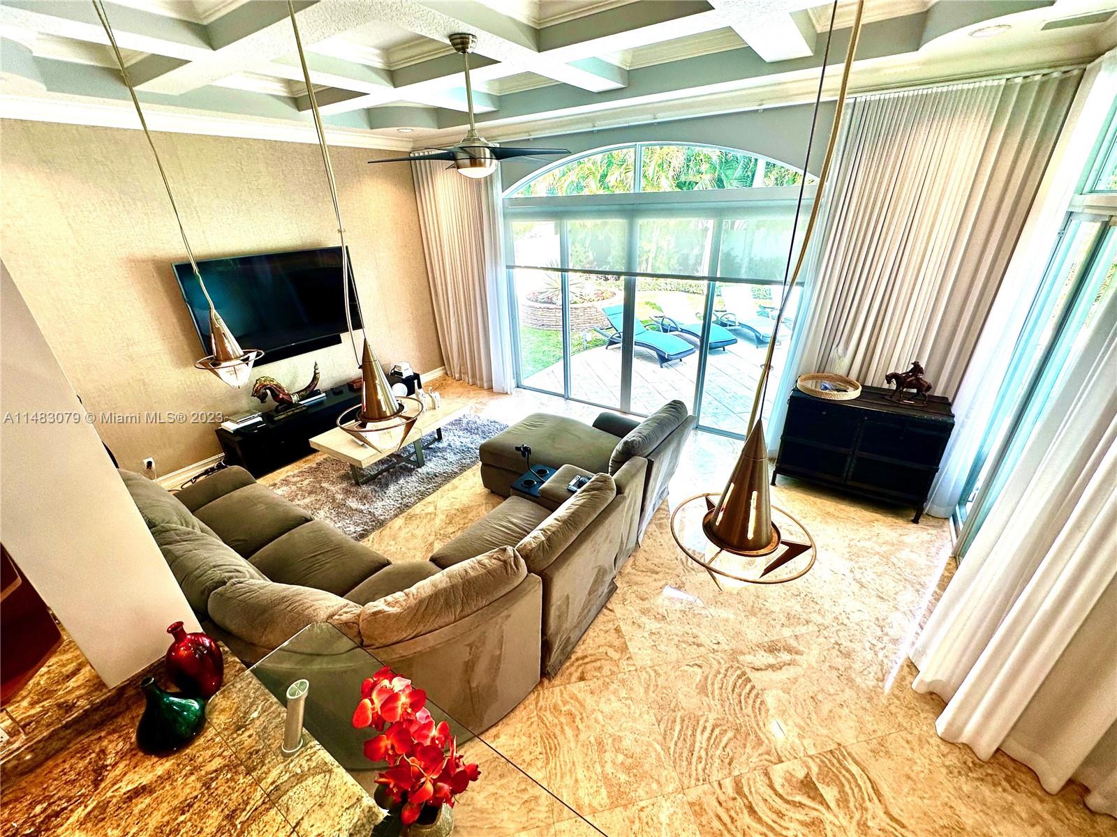 465 Northeast 2nd Street Boca Raton, FL 33432 - Photo 28 of 73 a living room with a couch and a flat screen tv