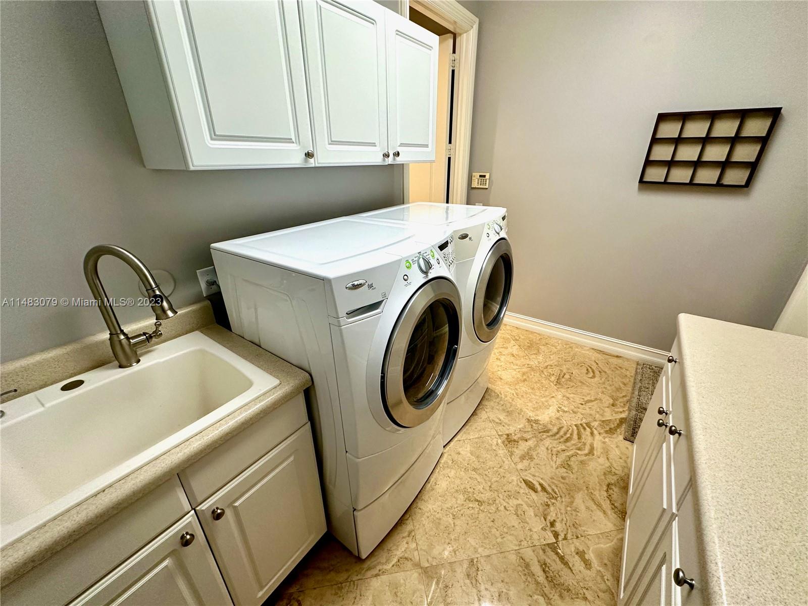 465 Northeast 2nd Street Boca Raton, FL 33432 - Photo 45 of 73 a utility room with dryer and washer