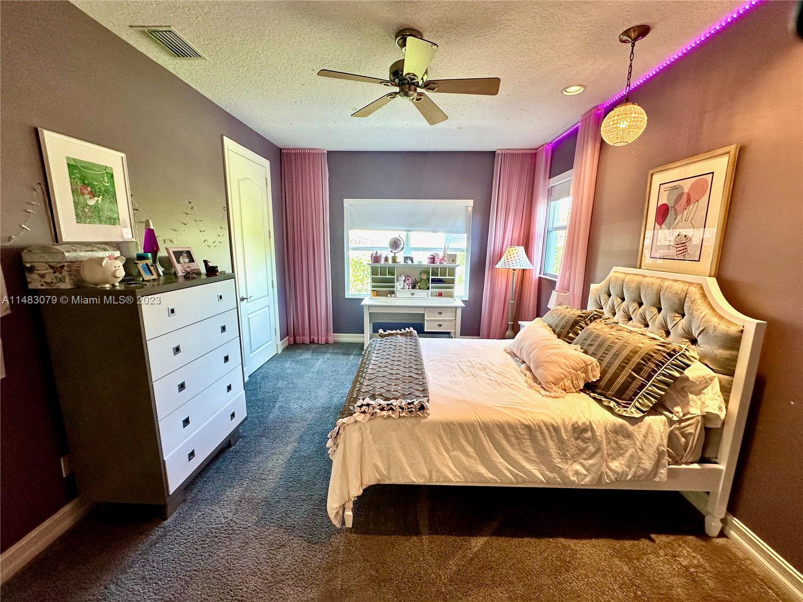 465 Northeast 2nd Street Boca Raton, FL 33432 - Photo 53 of 73 a bedroom with a bed and a chandelier fan