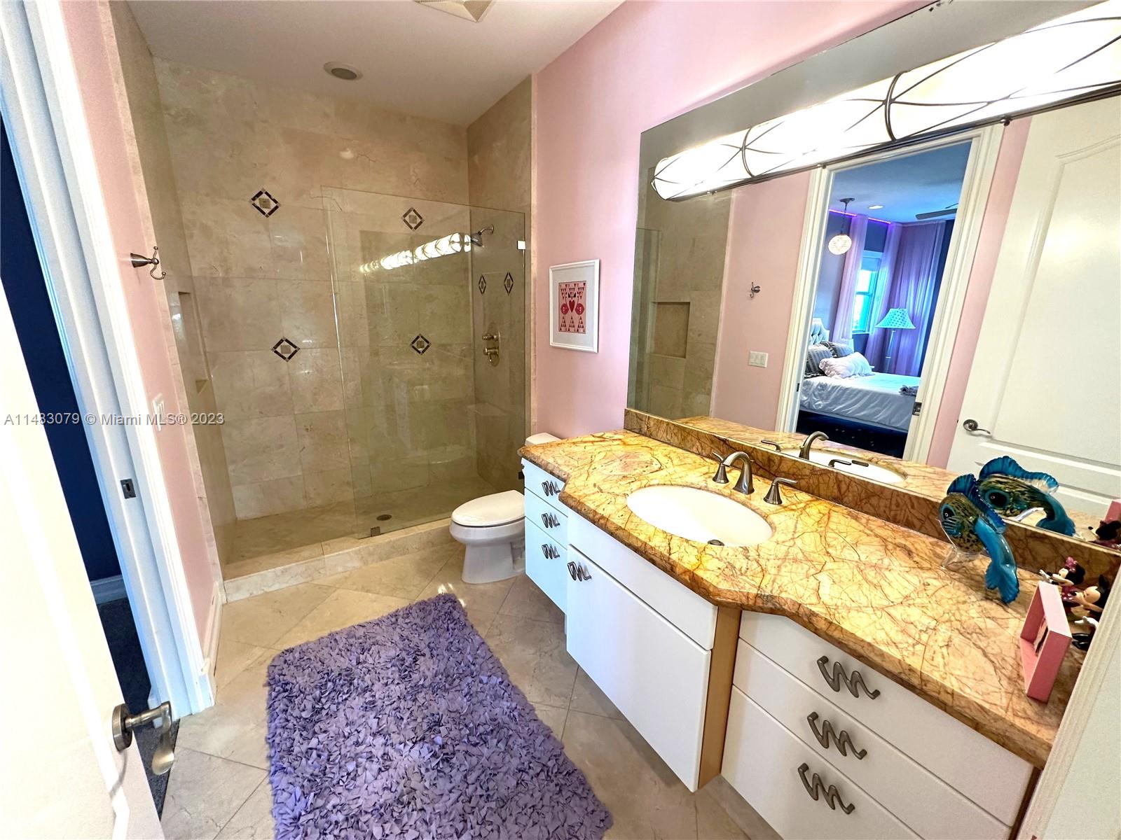 465 Northeast 2nd Street Boca Raton, FL 33432 - Photo 55 of 73 a spacious bathroom with a granite countertop tub sink and a mirror