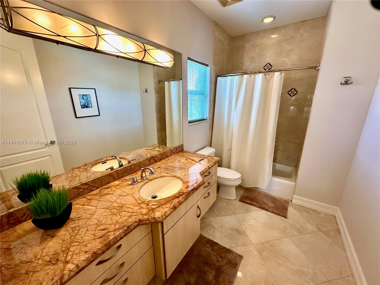465 Northeast 2nd Street Boca Raton, FL 33432 - Photo 59 of 73 a bathroom with a granite countertop sink a mirror and a shower