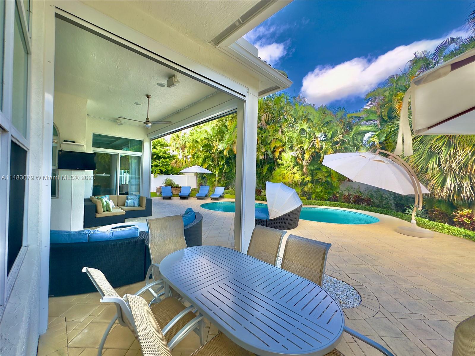465 Northeast 2nd Street Boca Raton, FL 33432 - Photo 62 of 73 a view of a patio with table and chairs potted plants with wooden floor