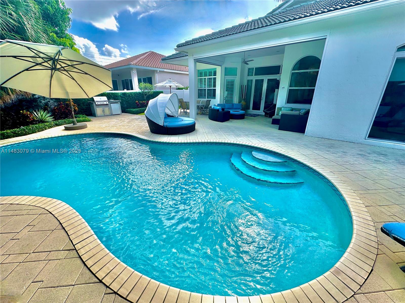 465 Northeast 2nd Street Boca Raton, FL 33432 - Photo 68 of 73 a view of a swimming pool with an outdoor seating