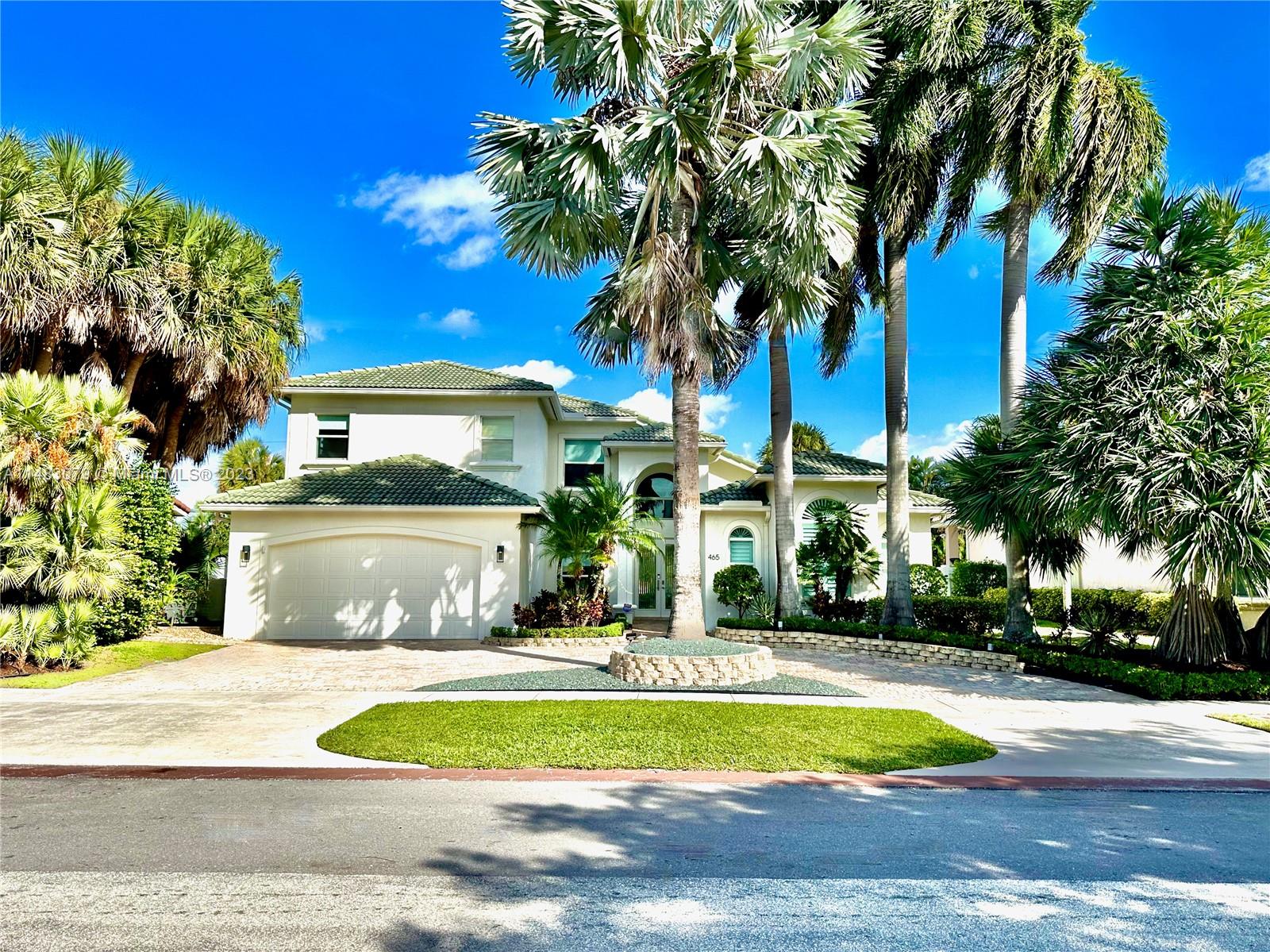 465 Northeast 2nd Street Boca Raton, FL 33432 - Photo 72 of 73 a front view of a house with a yard and trees