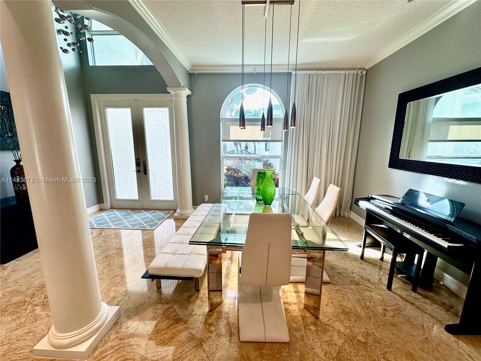 465 Northeast 2nd Street Boca Raton, FL 33432 - Photo 8 of 73 a view of a dining room with furniture window and wooden floor