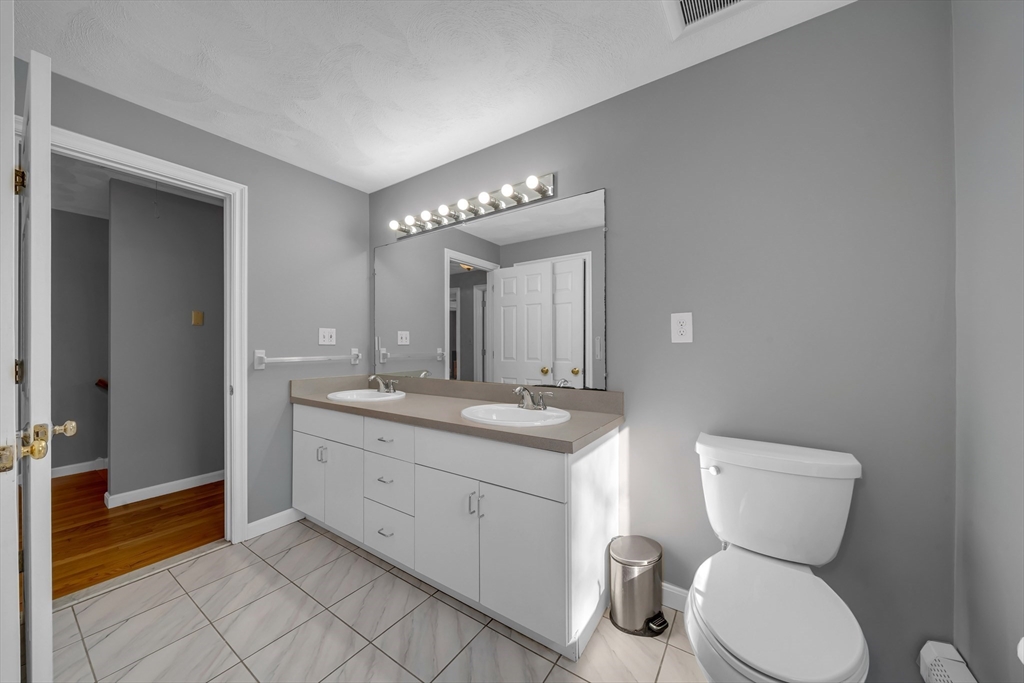 315 Candlestick Road North Andover, MA 01845 - Photo 39 of 42 a bathroom with a toilet sink and mirror