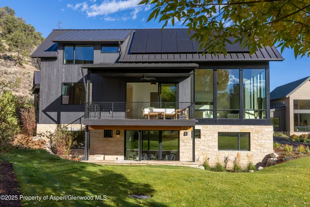 a view of a dining room with furniture large windows and wooden floor
