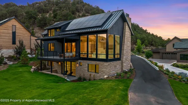 a living room with stainless steel appliances kitchen island granite countertop a table and chairs