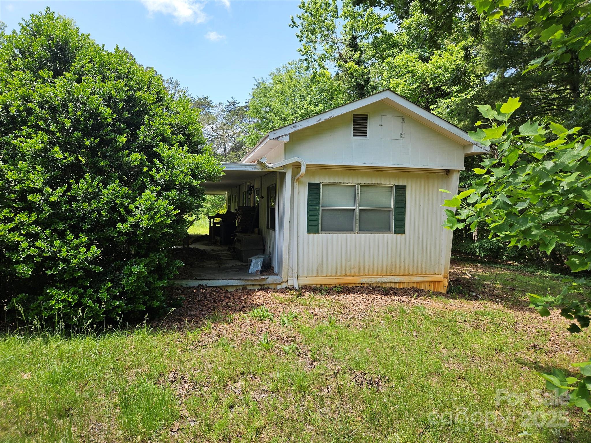 368 Settlemyre Road Morganton, NC 28655 - Photo 41 of 47 a view of front of a house with plants and trees