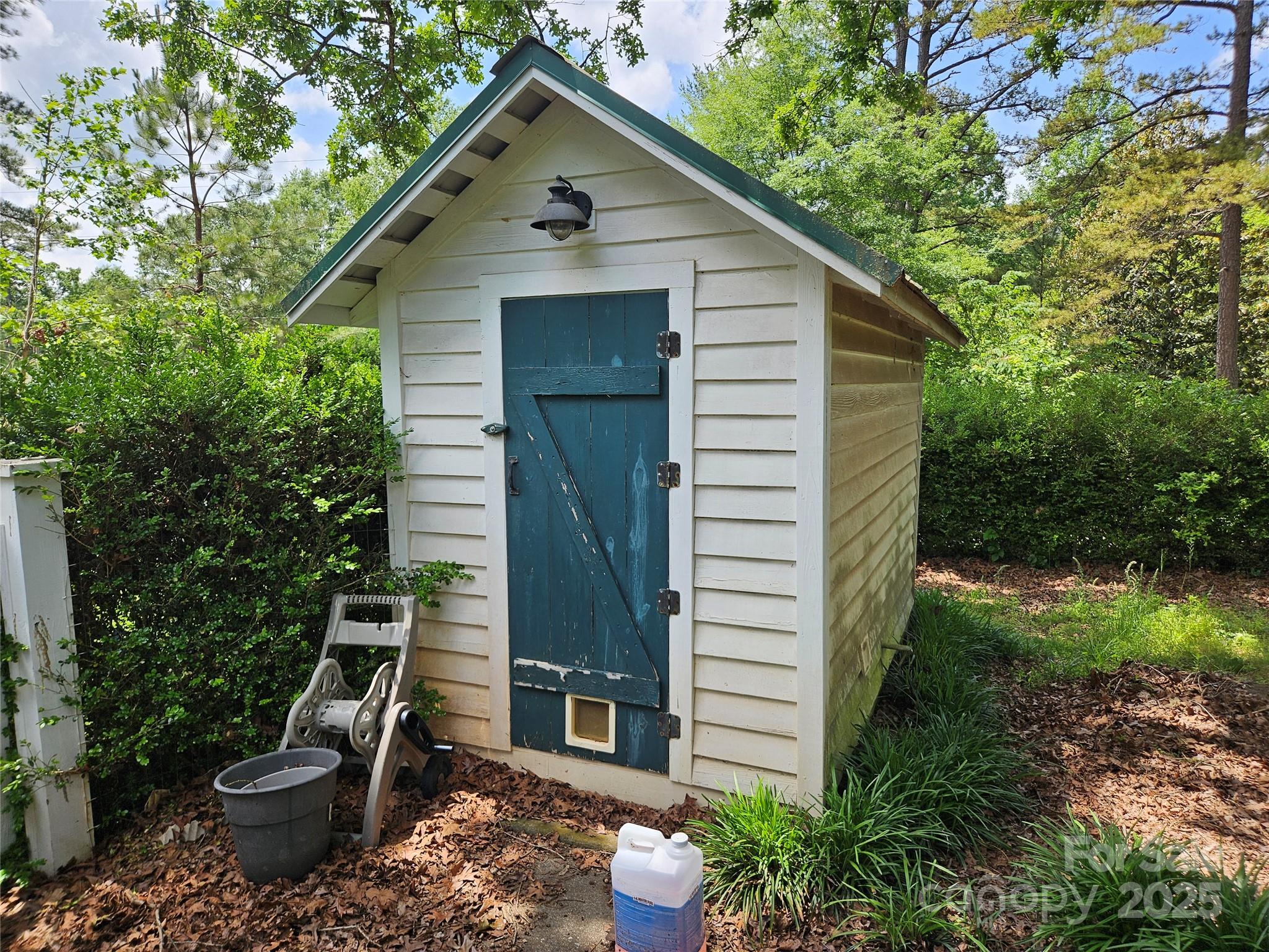 368 Settlemyre Road Morganton, NC 28655 - Photo 6 of 47 a view of a small house with plants and trees