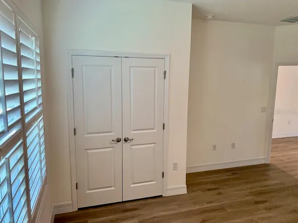an empty room with wooden floor