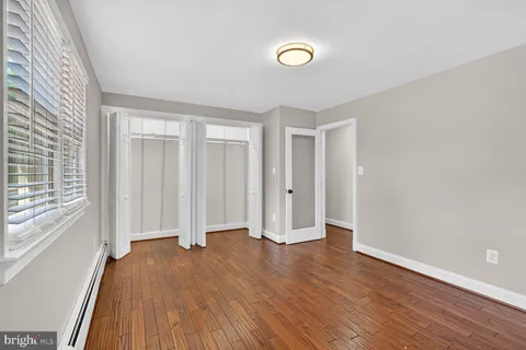 a view of a room with wooden floor and windows