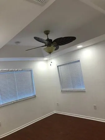 a view of room with a ceiling fan and window