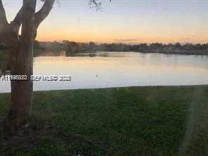 a view of a lake with houses in the back
