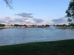 a view of a lake with houses in the back