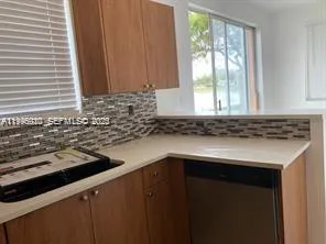 a kitchen with a sink and a window