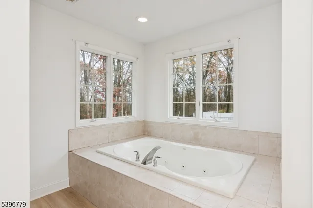 a bath tub sitting in a bathroom next to a window