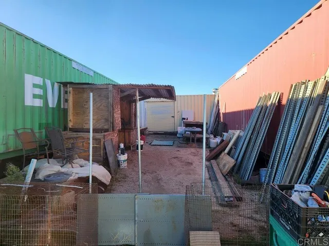 a view of a patio with chairs and potted plants