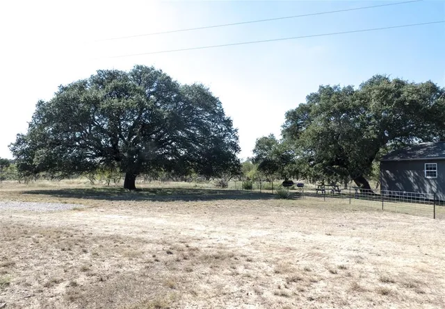 a view of a house with a yard covered with snow