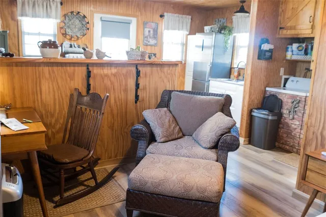 a living room with furniture a large mirror and a fireplace