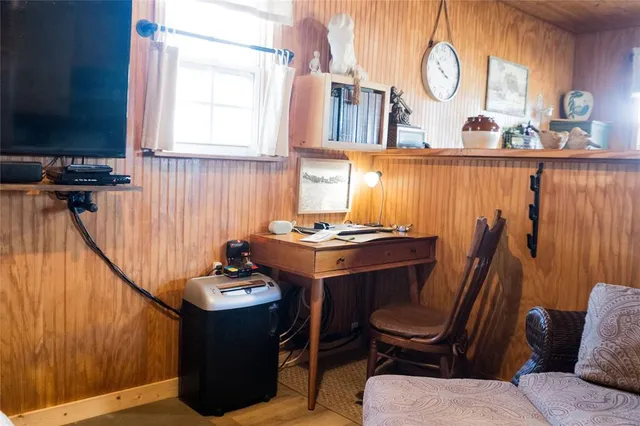 a view of a hallway with furniture and a window