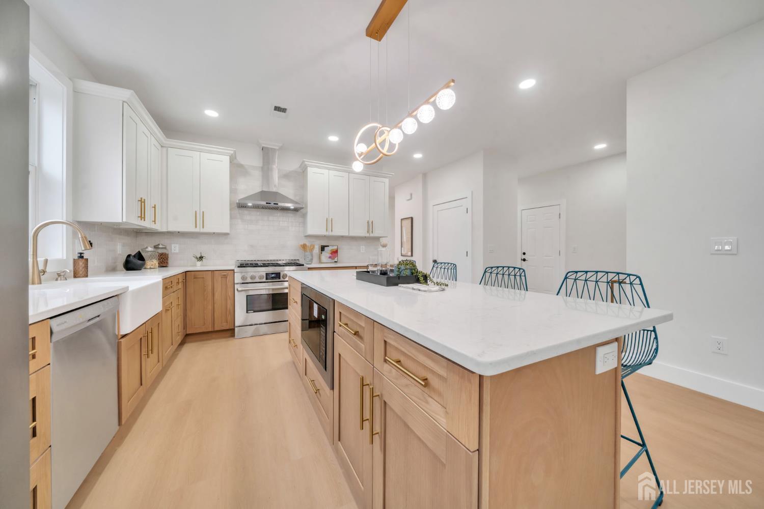 66 Garden Terrace Edison, NJ 08817 - Photo 12 of 40 a kitchen with white cabinets appliances and a sink