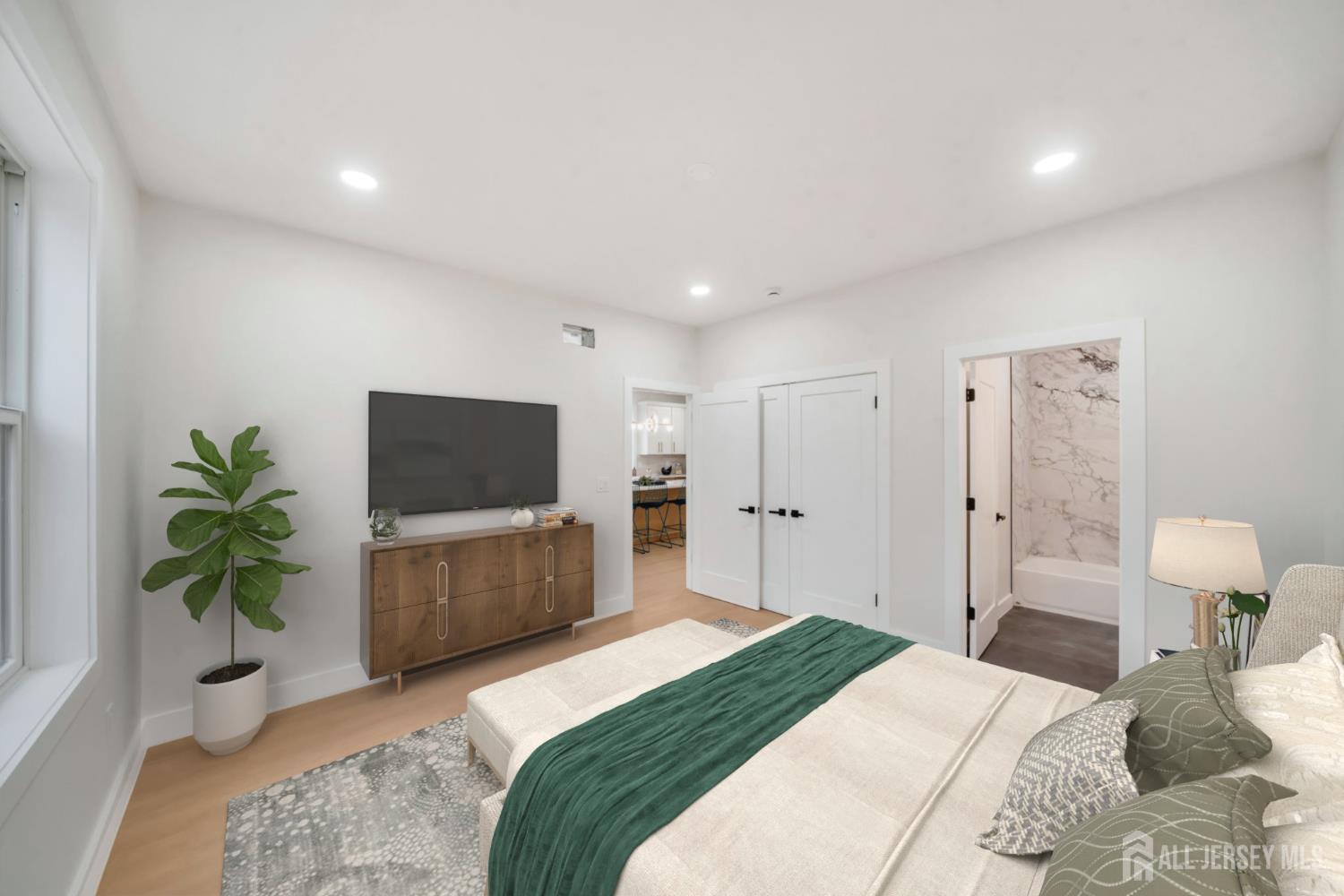 66 Garden Terrace Edison, NJ 08817 - Photo 19 of 40 a bedroom with a bed and a flat screen television