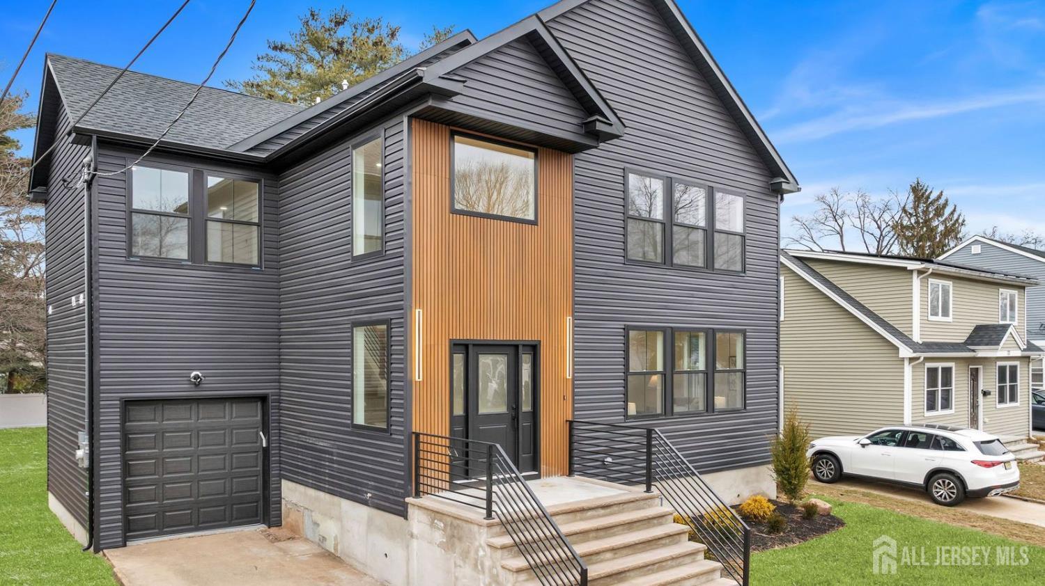 66 Garden Terrace Edison, NJ 08817 - Photo 2 of 40 a car parked in front of a white house