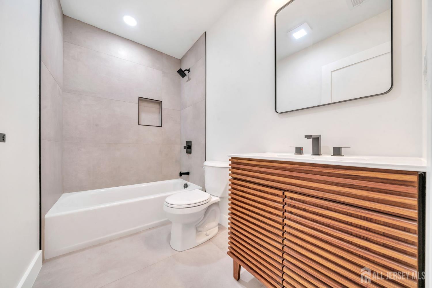 66 Garden Terrace Edison, NJ 08817 - Photo 35 of 40 a bathroom with a toilet a sink and bathtub