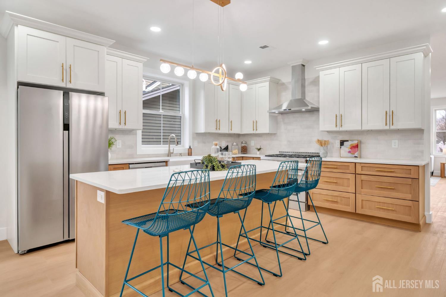 66 Garden Terrace Edison, NJ 08817 - Photo 10 of 40 a kitchen with stainless steel appliances granite countertop a sink a stove a refrigerator and island with wooden cabinets