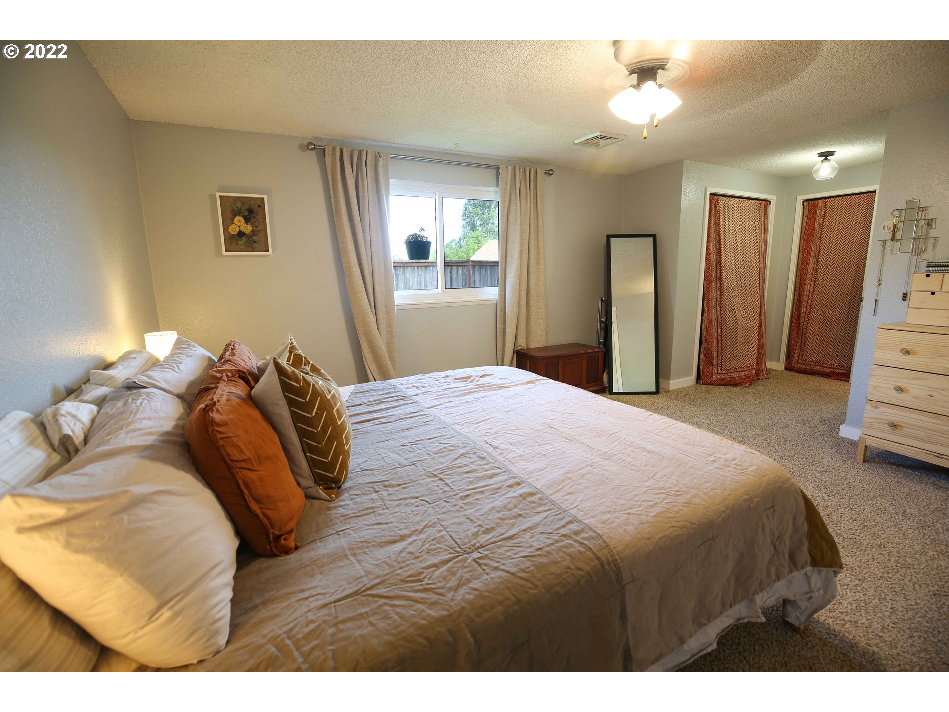 1071 Cole Way Springfield, OR 97478 - Photo 12 of 30 a bedroom with a bed and a lamp