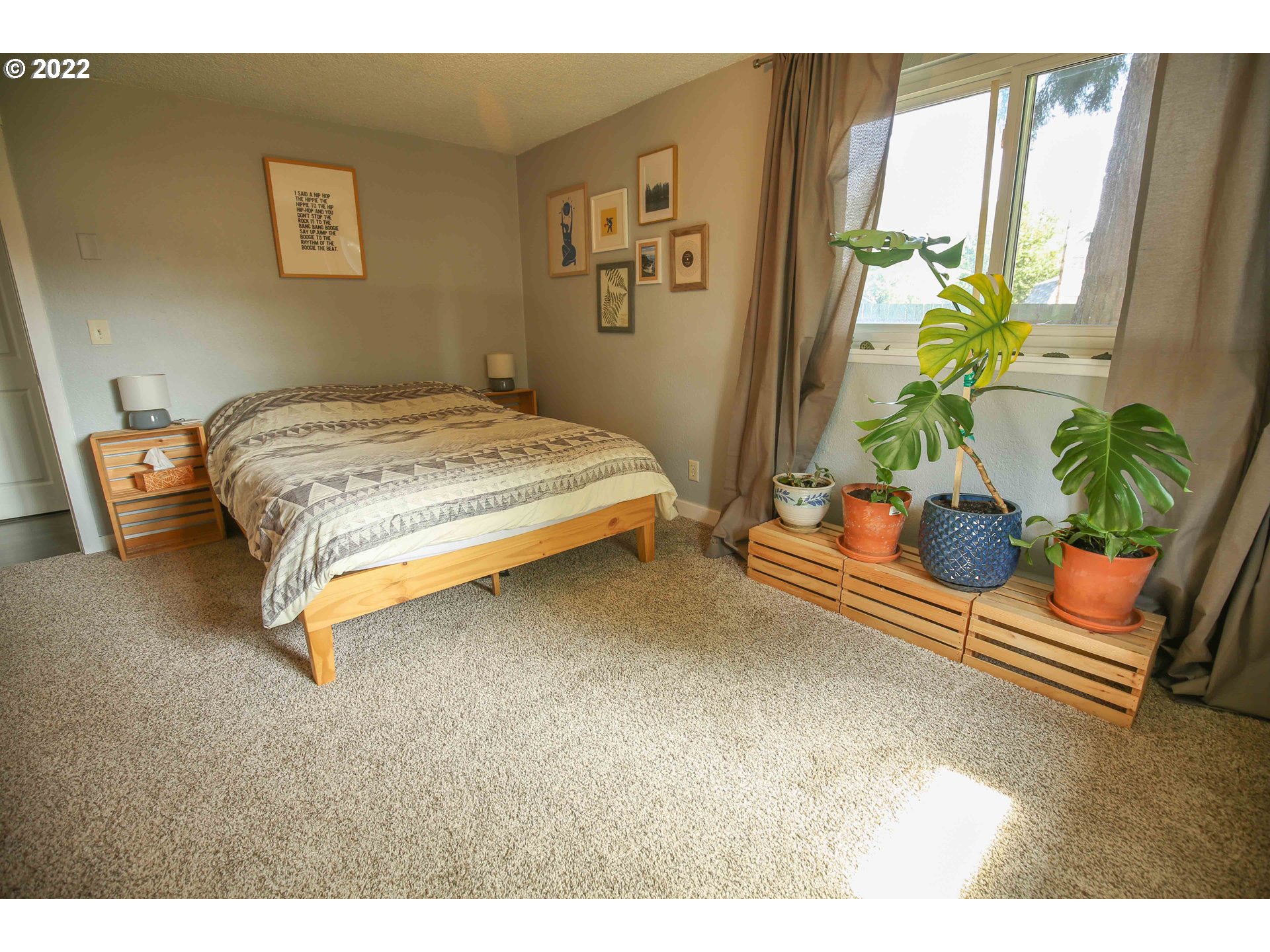 1071 Cole Way Springfield, OR 97478 - Photo 15 of 30 a bedroom with a bed table and a potted plant