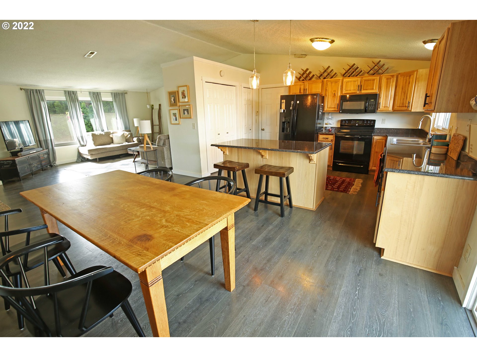 1071 Cole Way Springfield, OR 97478 - Photo 5 of 30 a view of a dining room with furniture and wooden floor